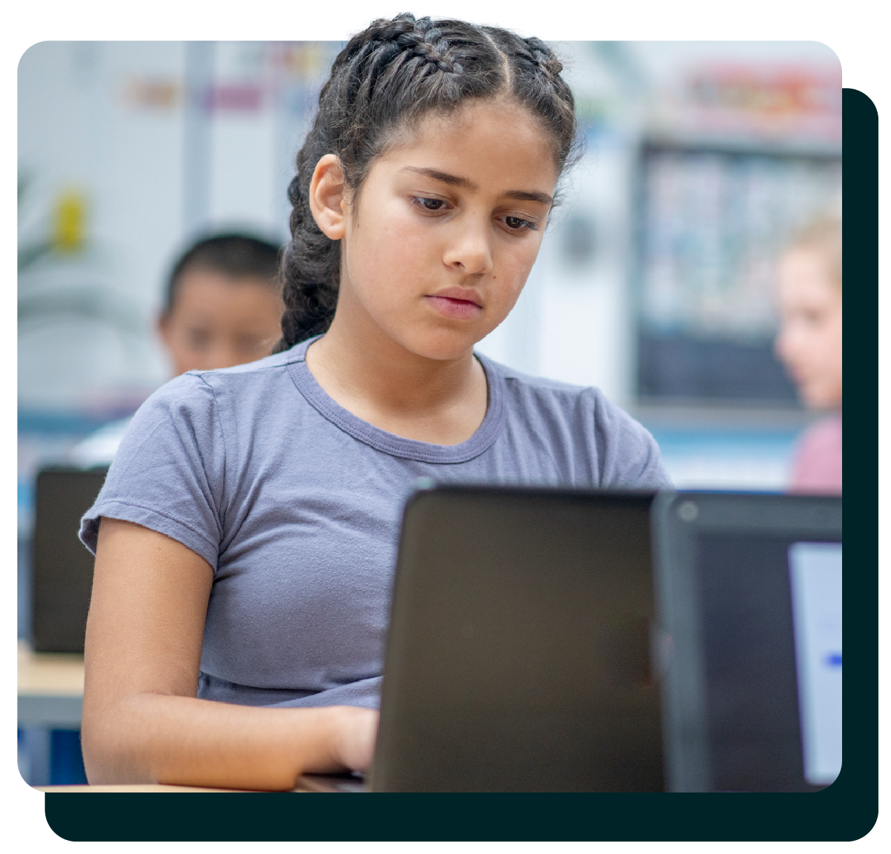Middle school girl reading on a laptop