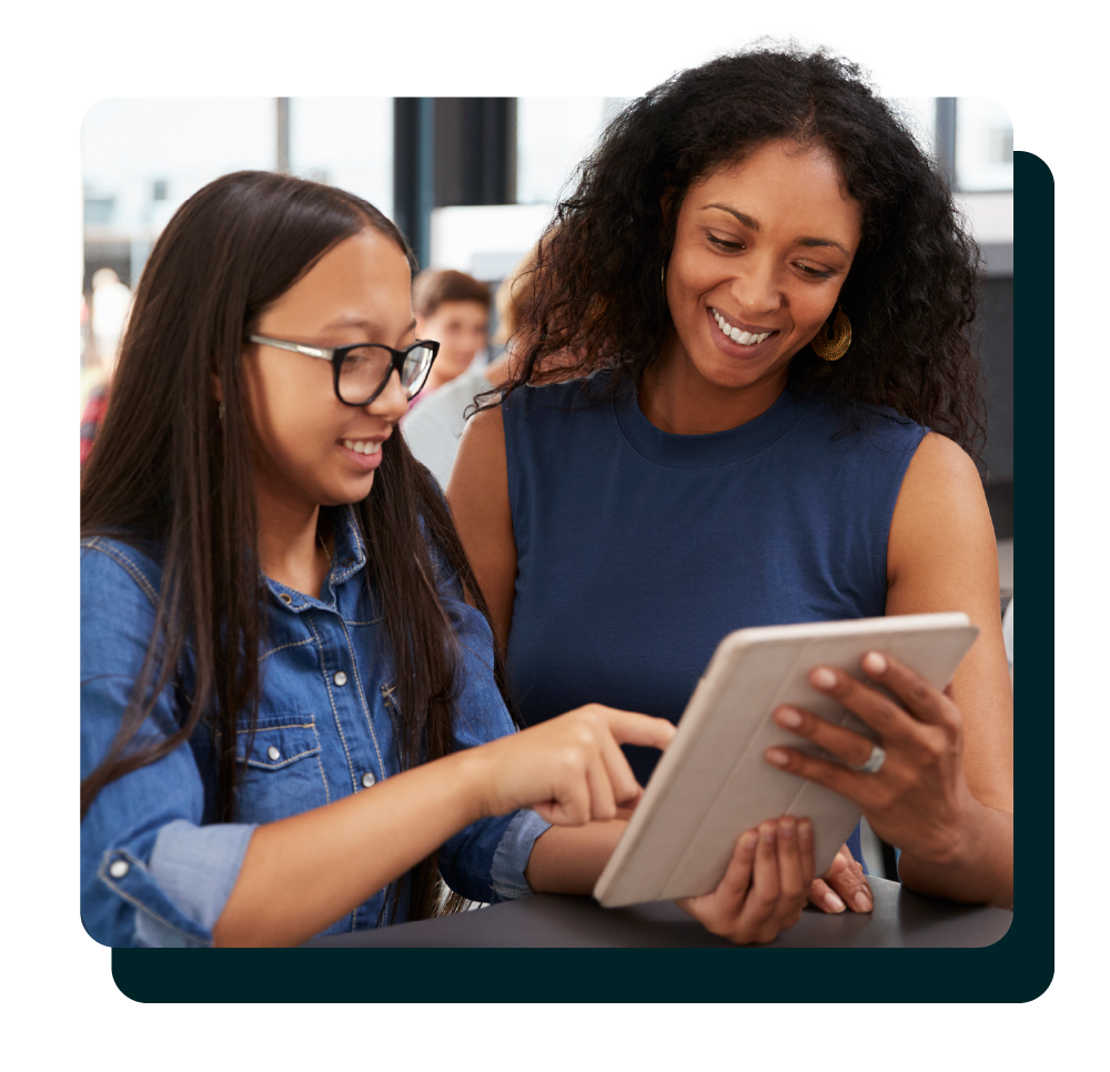 Teacher and middle school student looking at a tablet with intent