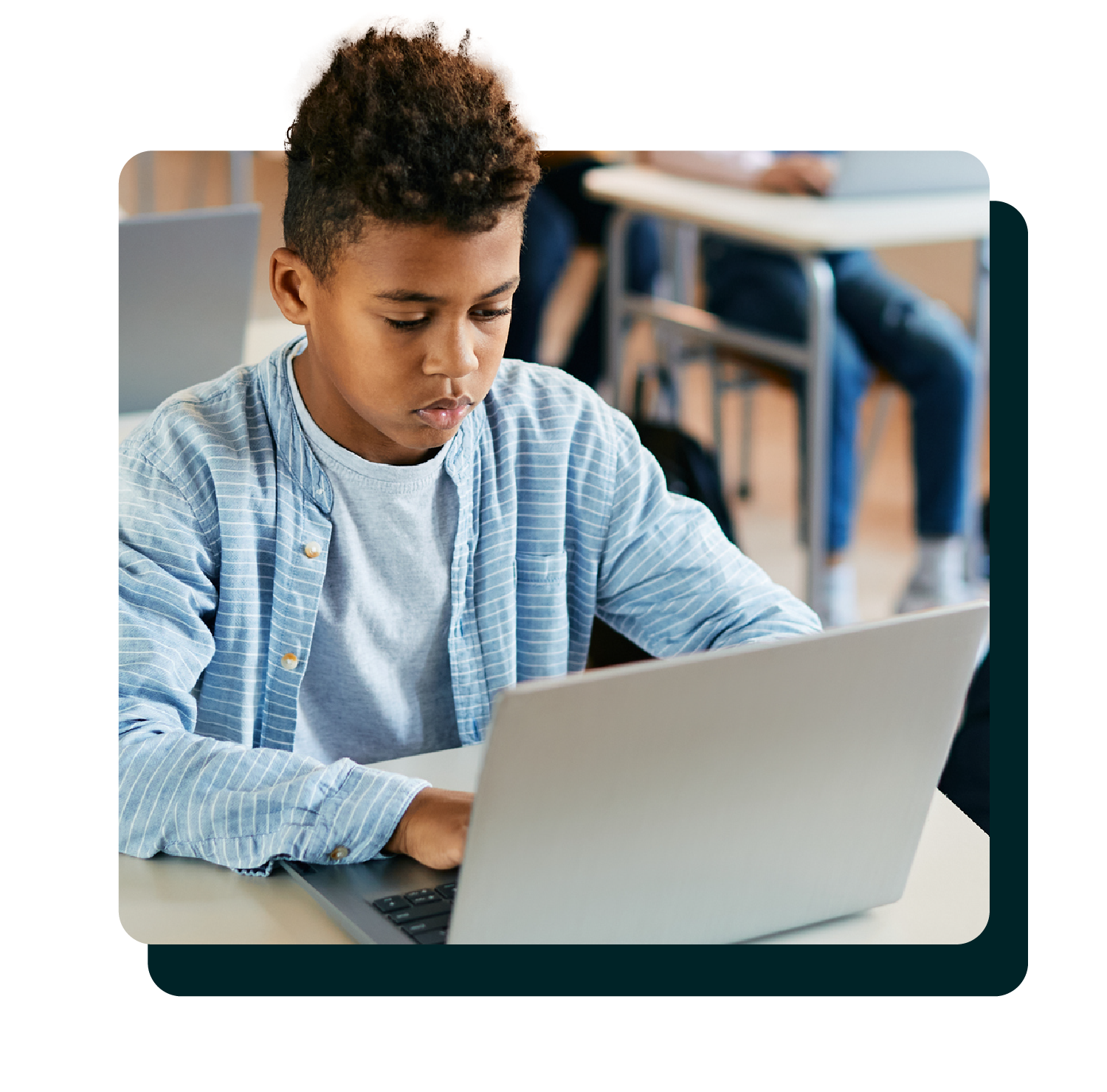 Middle school student looking at laptop